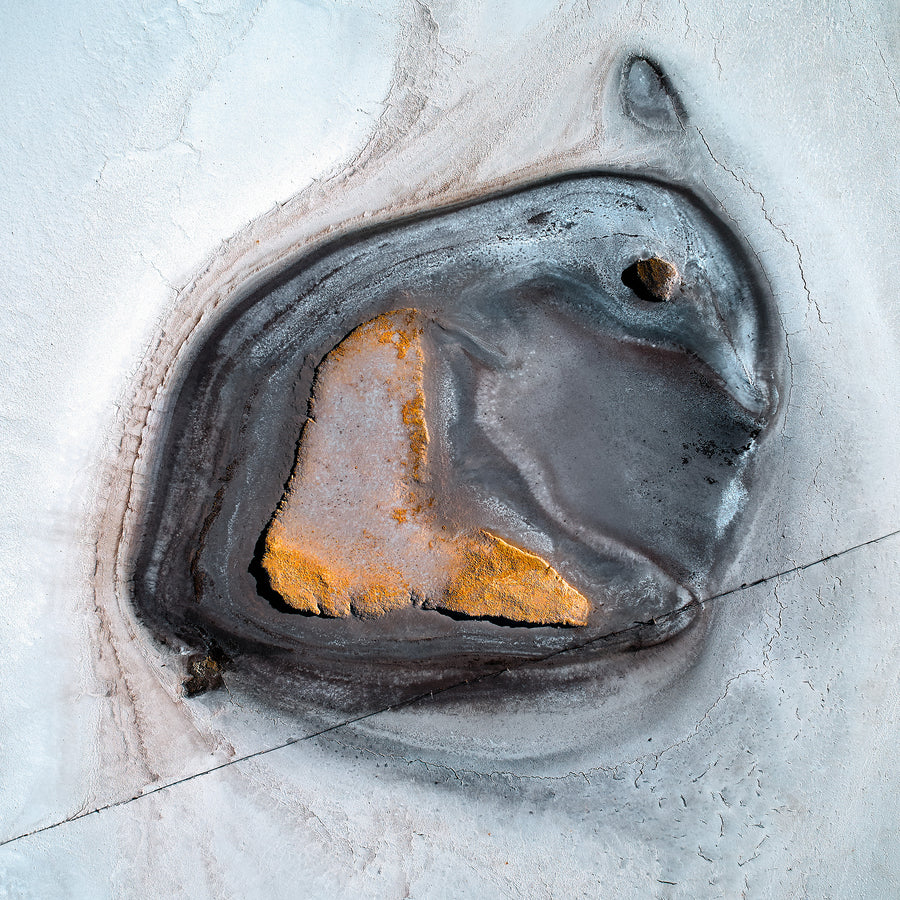 An aerial photograph of a salt lake over the Wheatbelt in Western Australia.  This looks like a bunny or an emperor penguin.  White, black and yellow colours.