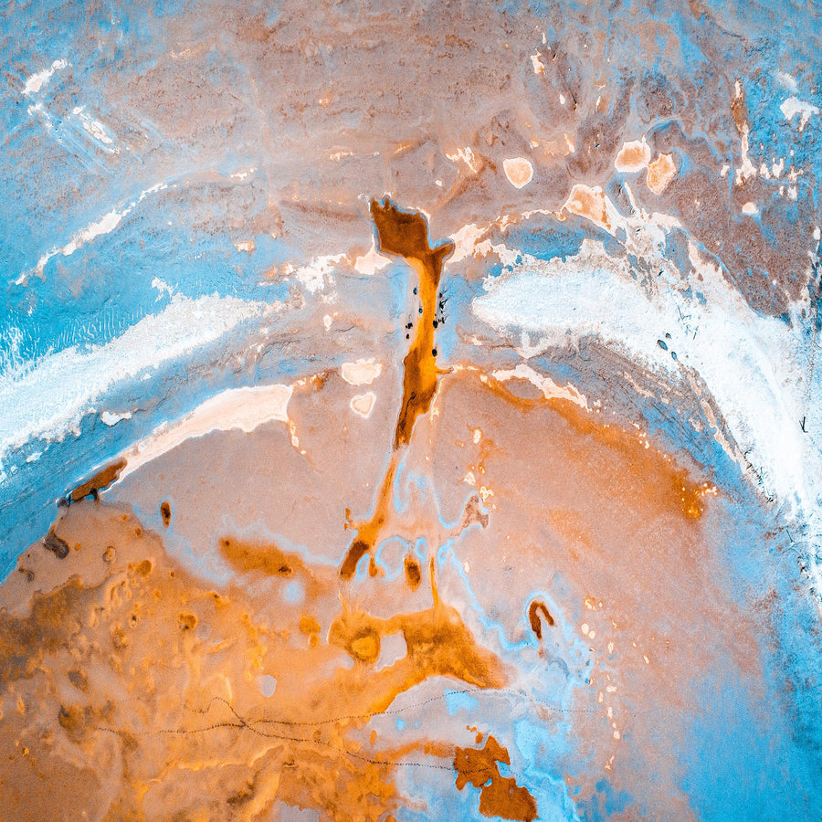 A blue, rust and white coloured aerial abstract of a mid western Australian salt lake, looking more like the planet view from a space ship.