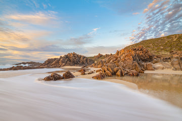 Beautiful sunset photograph of the beach at Wyadup, South Western Australia.  Granite rocks, pristine sand and orange sky.